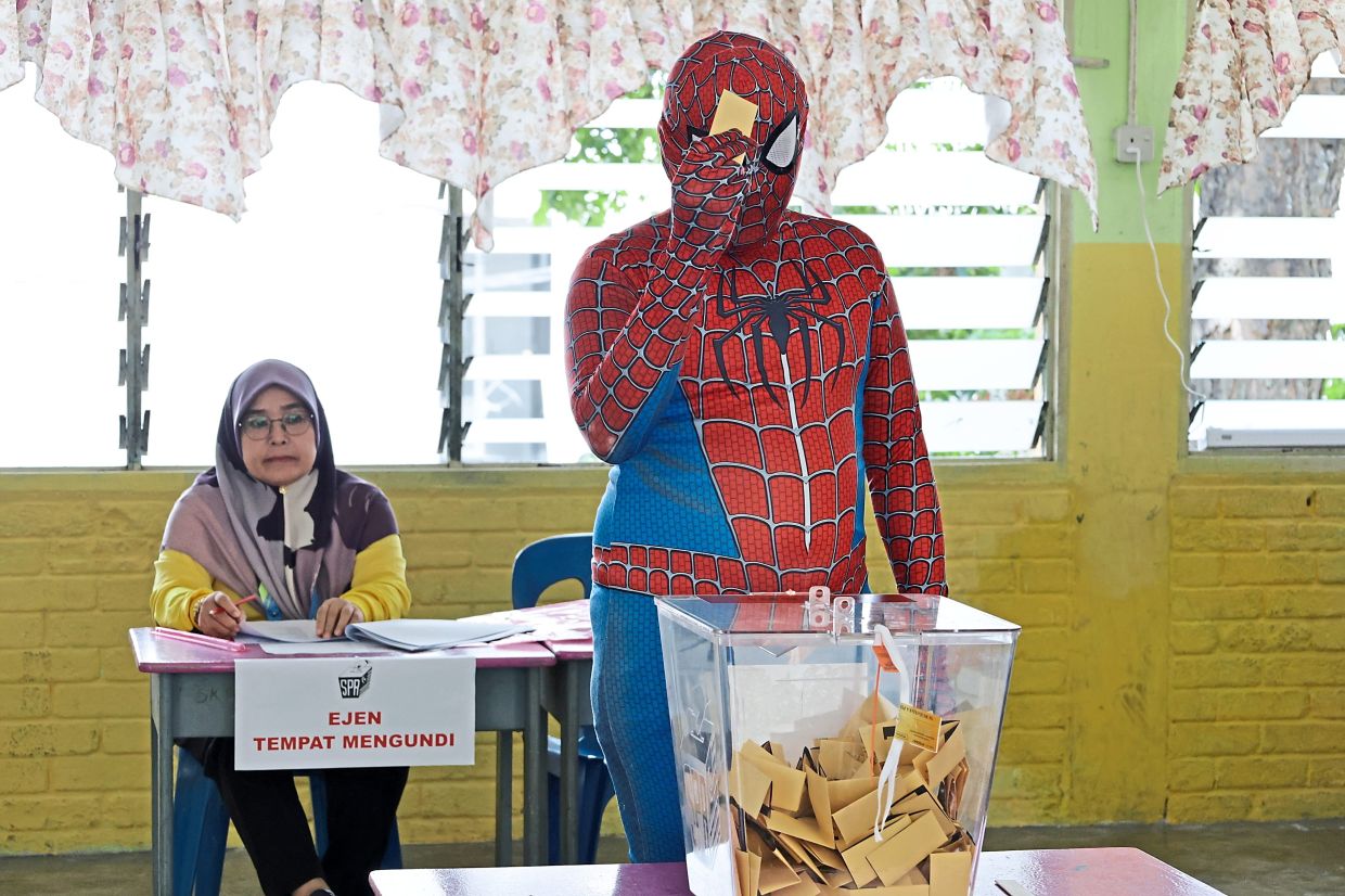 Muhamad Sharizal dressed as Spider-Man to cast his vote for the Air Itam state seat at SK Sri Aman in Kampung Melayu, Ayer Itam. — Filepic