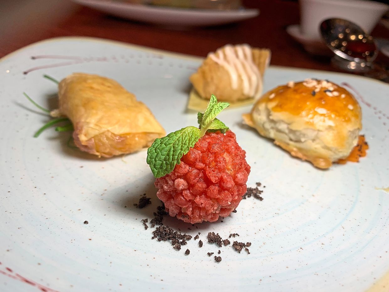 Chynna offers diners a tea-pairing session with dim sum and mooncakes (above), served up in a performance by its tea master (right).
