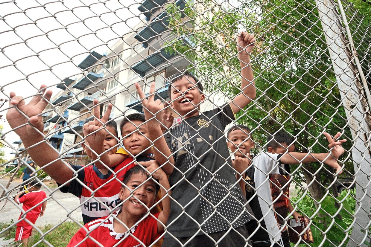 'The Kids (Behind The Fences)'. It was during the George Town's Heritage Celebration in Penang when we were walking the streets which were full of celebrations, performances and stalls selling foods and souvenirs. Then I saw this group of children playing in a compound nearby that was separated by a fence but they too were enjoying the celebration in their own way, recalls Lim. Photo: Lim Kim Boon 