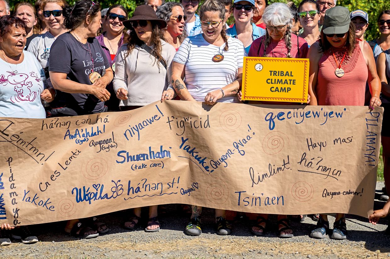 Attendees of the 2023 Tribal Climate Camp organising themselves to take a photo near Port Angeles, Washington.
