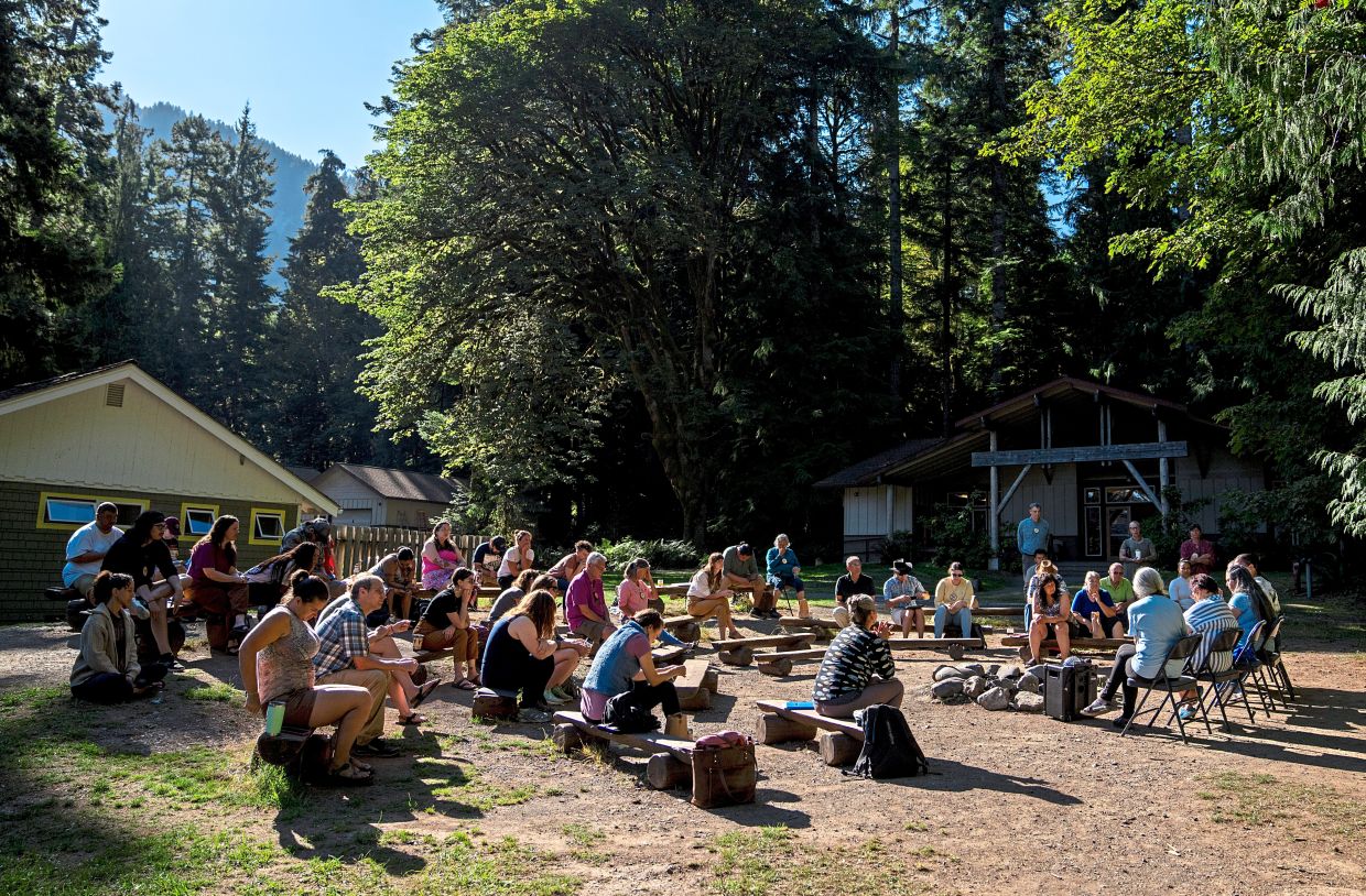  Participants gathering for a morning session on the log benches at NatureBridge in the Olympic National Park during the camp. — AP