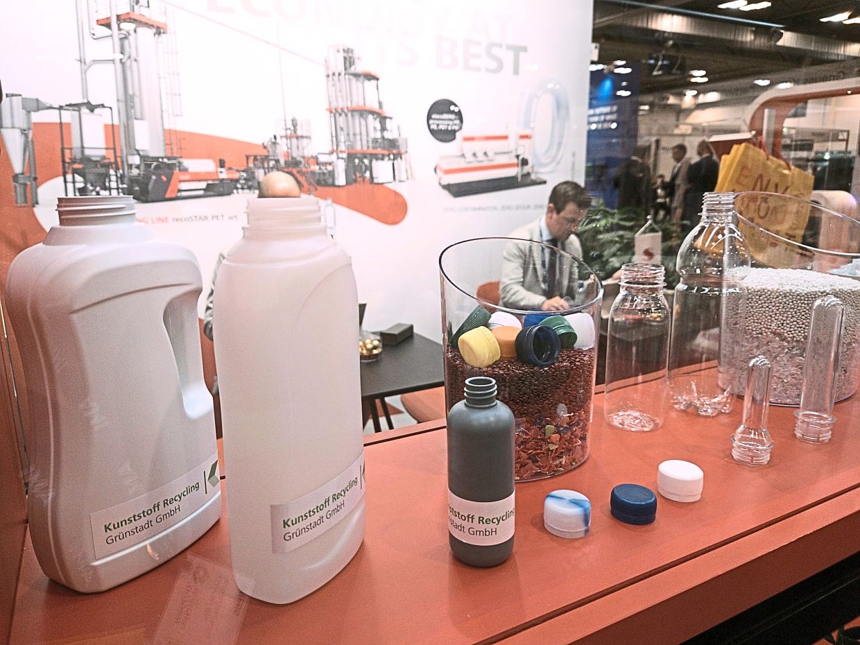 An exhibitor at the Plastics Recycling World Exhibition in Essen displaying plastic products and various stages of recycling. — SIM LEOI LEOI/The Star