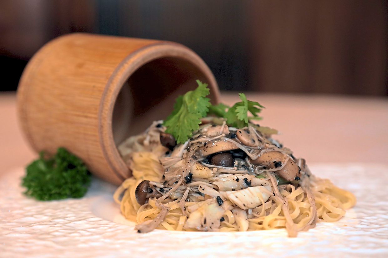 Stewed Egg Noodles with Crab Meat and Truffle in Bamboo Cup.