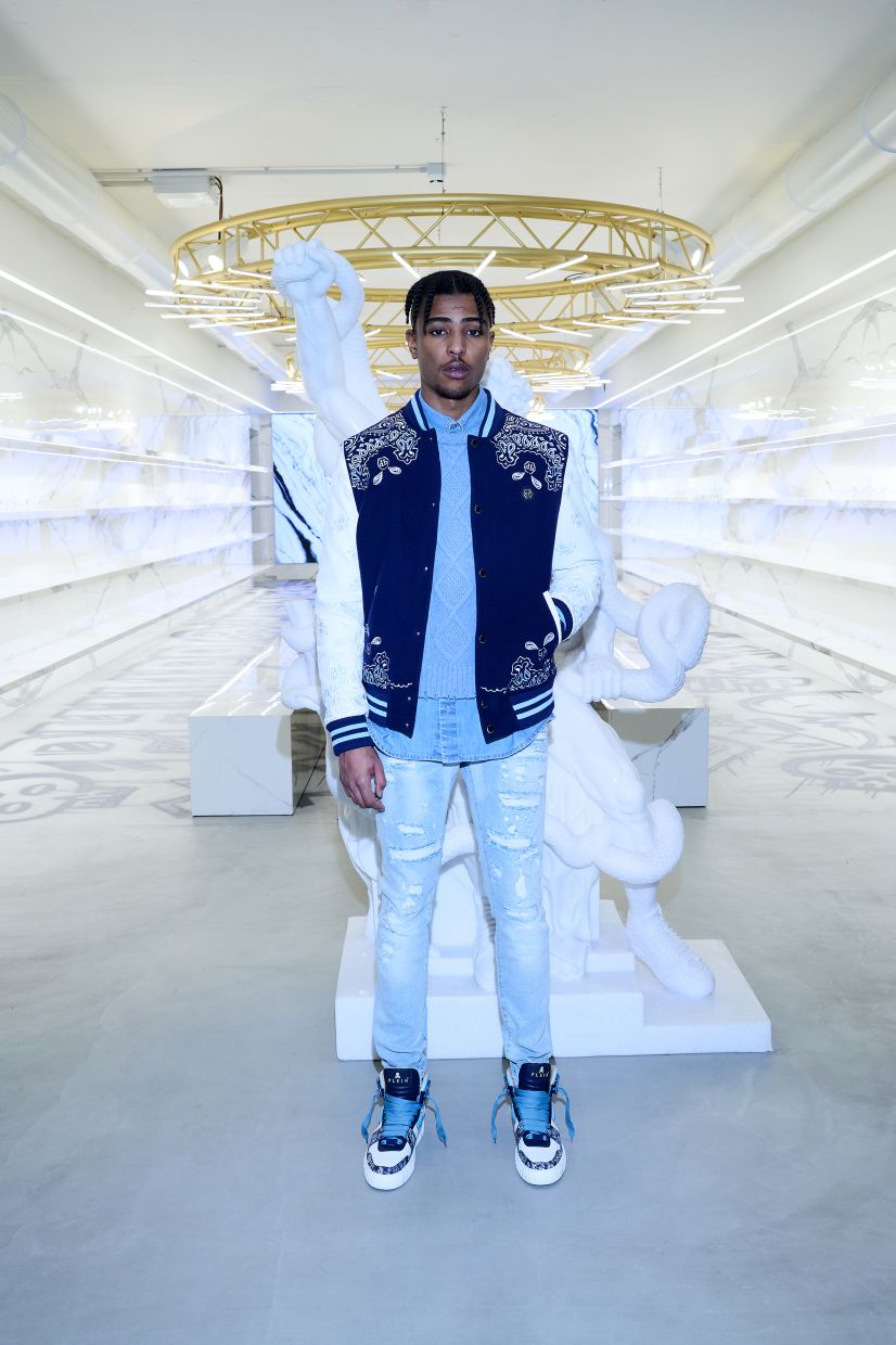 Maintaining the streetwear energy with tattered jeans matched with a denim shirt, sweater and sneakers. Photo: Philipp Plein