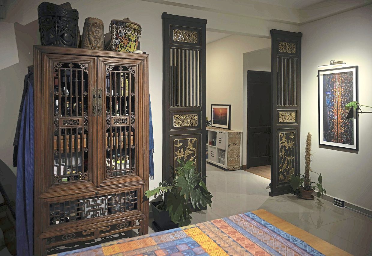 The Chinese chicken coop-design elm wood cupboard (left) and traditional carved doors (right), made with recycled wood.