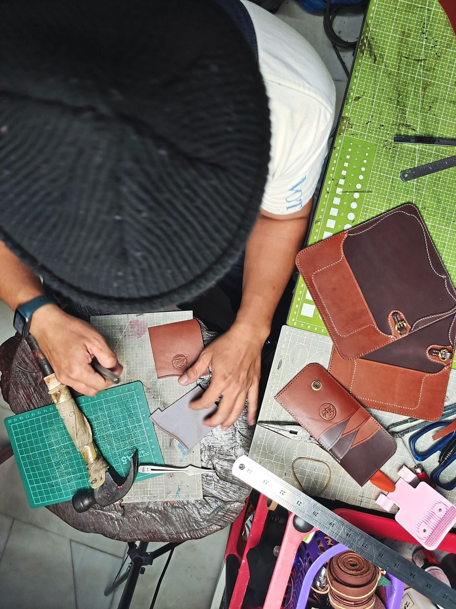 Wan Noorazhardy, surrounded by the scent of full-grain leather, finds inspiration and joy in his leathercrafting journey.- DIANA YAN MANAN