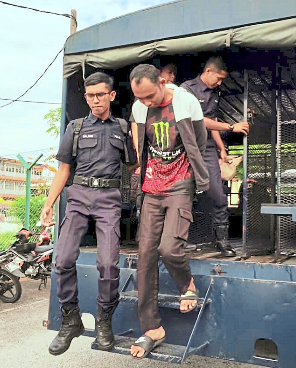 Day in court: The accused being taken to the Port Dickson Magistrate’s Court to be charged.