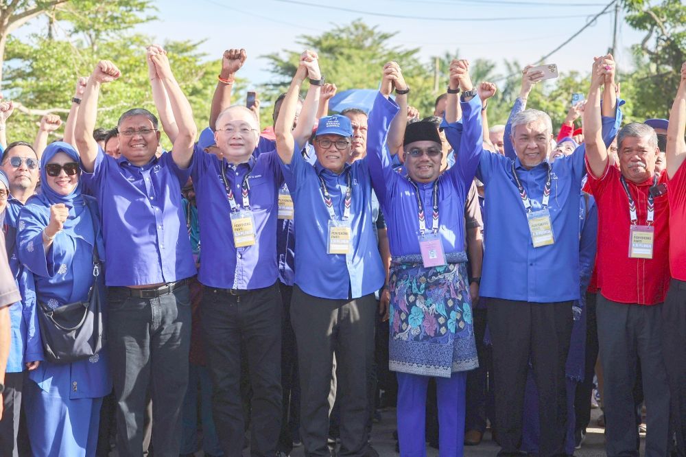 BN’s candidate Datuk Amizar Abu Adam (third from right) arriving at the nomination centre with his supporters on Saturday.