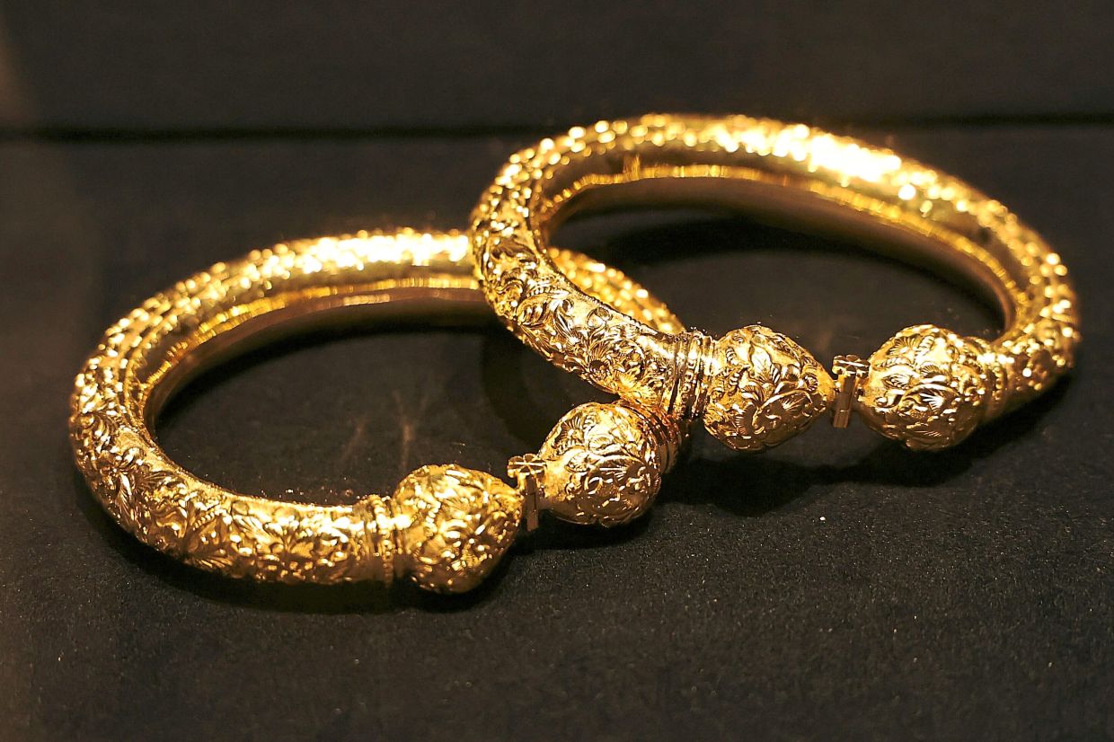 An exhibit displaying a pair of gelang kaki (anklets) in 18K yellow gold. Photo: The Star/Azman Ghani