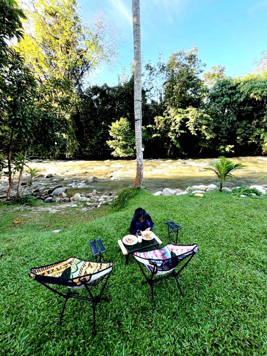 Lily's daughter getting ready to have her meal at the campsite by the river in Gopeng where Lily contracted a water-borne disease.