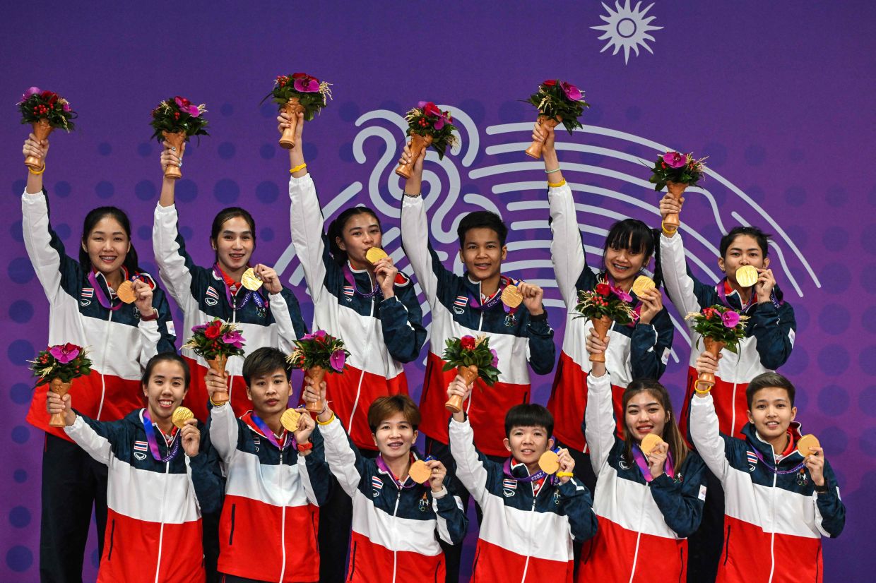 Members of Thailand's team pose for photos with their gold medals during the medals ceremony for the women's team sepak takraw event during the Hangzhou 2022 Asian Games in Jinhua in China's eastern Zhejiang province on Friday, September 29, 2023. - AFP