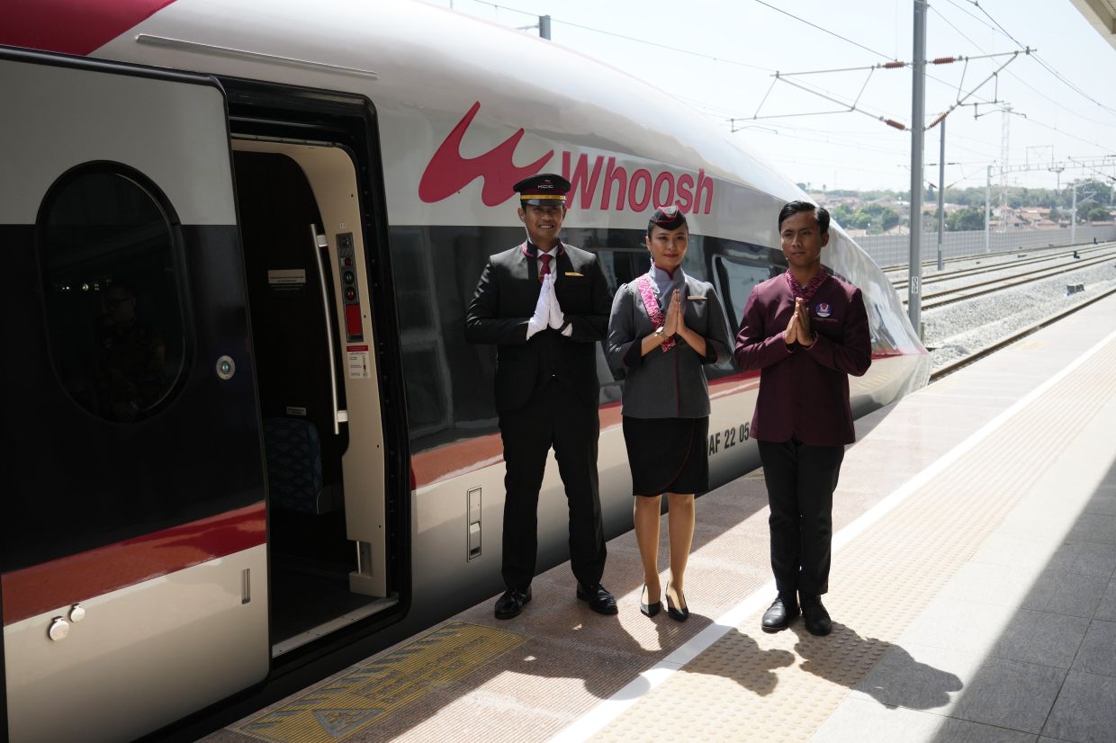 Officials stand near of high-speed railway during the opening ceremony for launching Southeast Asia's first high-speed railway at Padalarang station in Bandung, West Java, Indonesia, Monday, Oct. 2, 2023. Indonesian President Joko Widodo launched Southeast Asia's first high-speed railway that will start its commercial operations on Monday, a key project under China's Belt and Road infrastructure initiative that will cut travel time between two cities from the current three hours to about 40 minutes. - AP