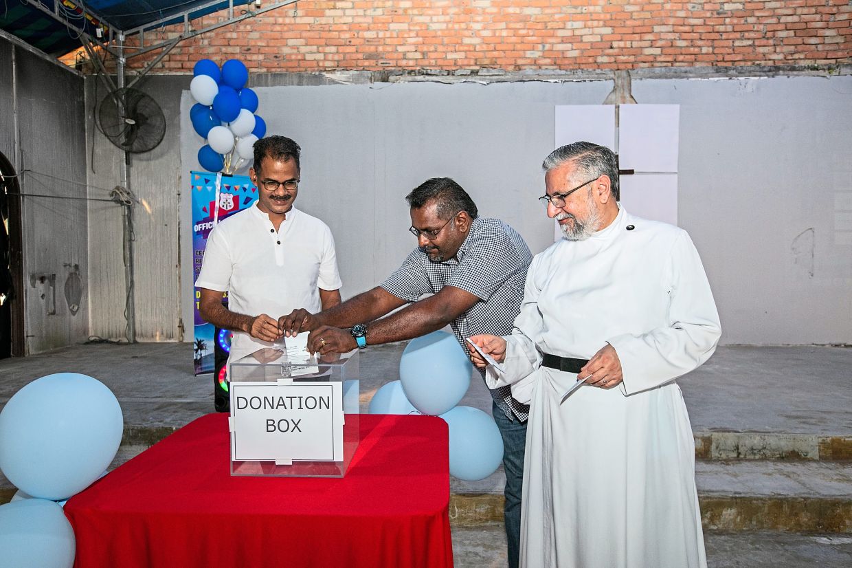 (From left) Papparaidu, Kuala Langat parliamentary coordinator Haridass Ramasamy and Rev Mathew launching the campaign by dropping  contributions into the  collection box.