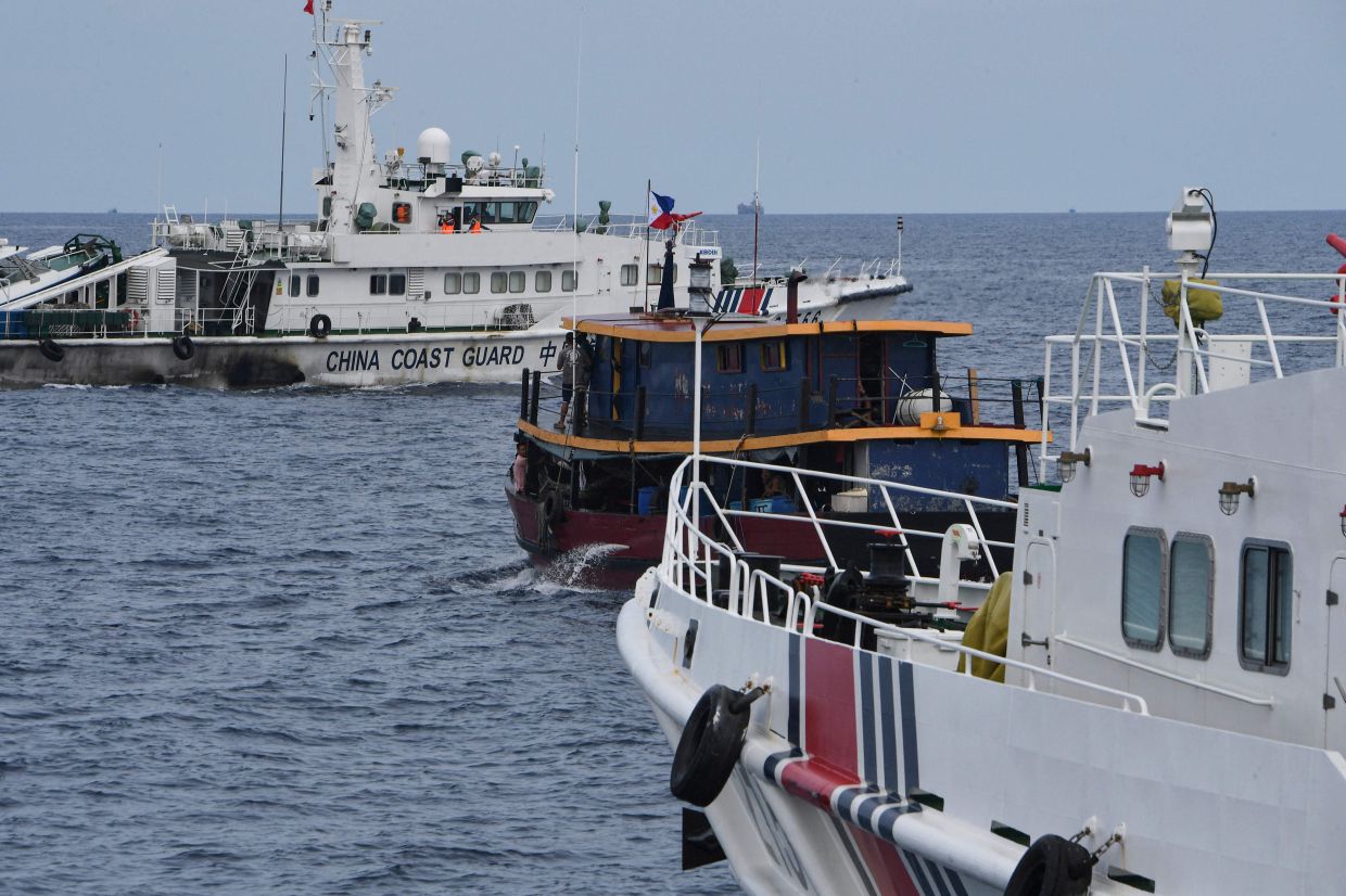 Philippine boats breach a Chinese coast guard blockade in a faceoff near disputed shoal - Vimarsana News