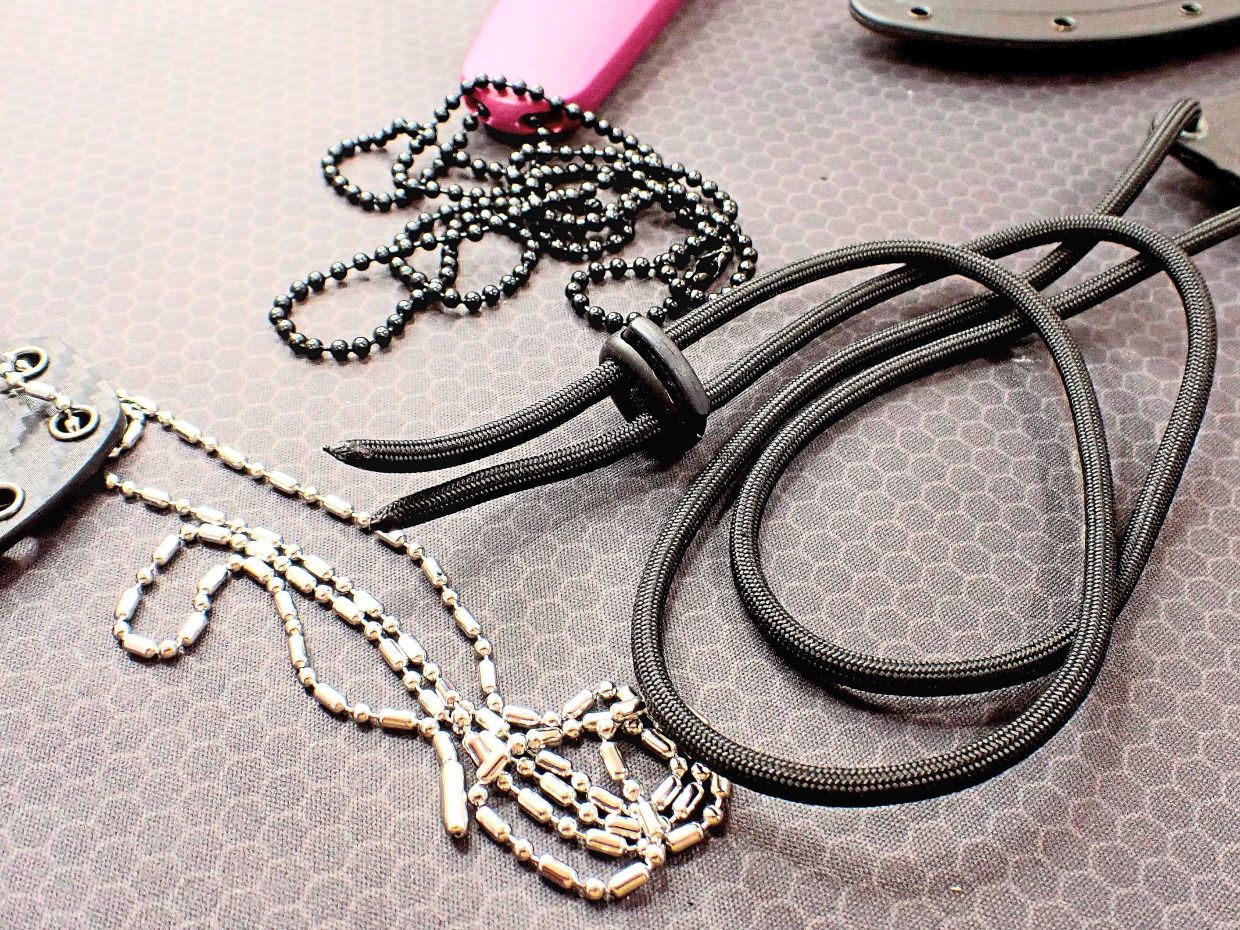 Always wear a neck knive with a ball chain or lanyard with breakaway plastic clasps that will safely snap when too much pressure is used.