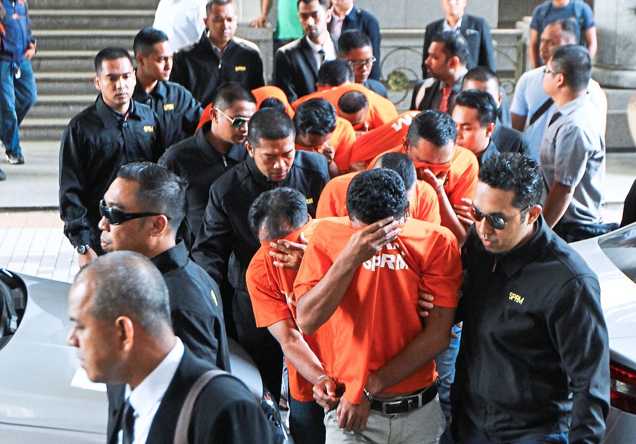 File photo of 14 individuals, including a police station chief and two officers, arrested by the Malaysian Anti-Corruption Commission over a protection racket. The public knows there are corrupt cops but perhaps we don’t realise the extent of the rot. — Filepic/The Star