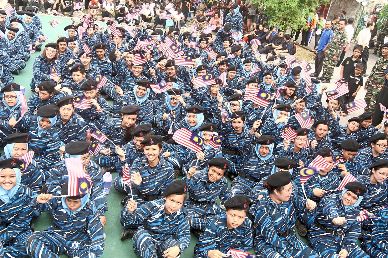 Proud to serve: National service trainees waving their flags at the Malaysian Armed Forces Open Day at the Integrated Recreational entre in Kuching.