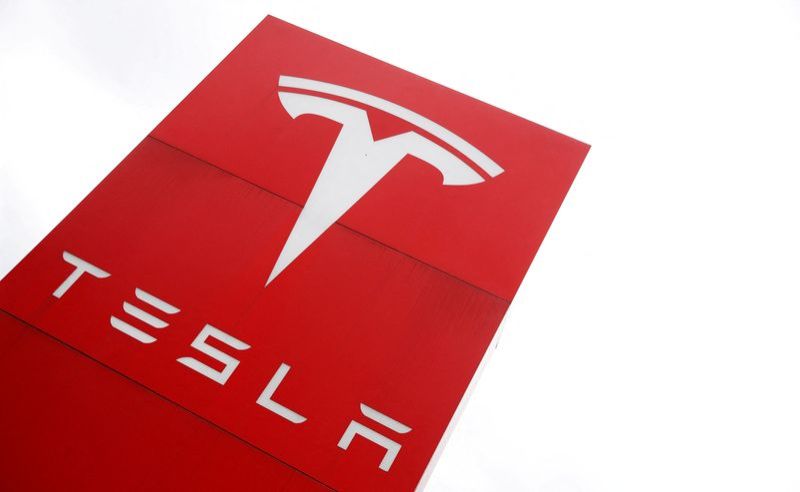 FILE PHOTO The logo of car manufacturer Tesla is seen at a dealership in London Britain May 14 2021. REUTERSMatthew ChildsFile Photo