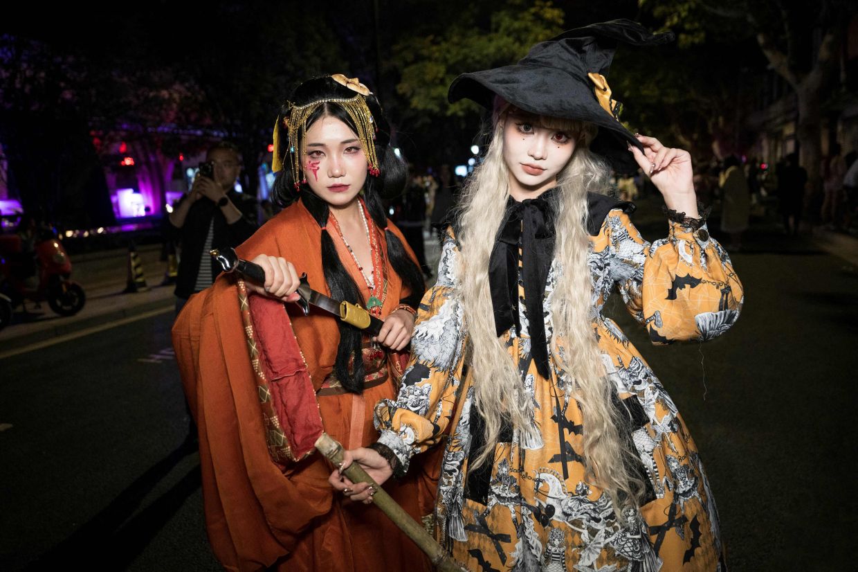 Halloween revellers throng Shanghai, some in costumes seen as a protest