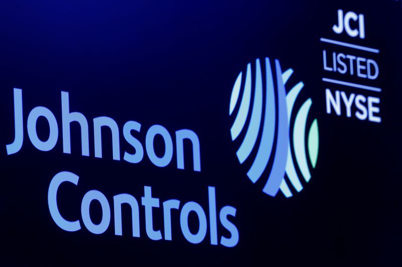 FILE PHOTO The logo and trading symbol for Johnson Controls International is displayed on a board on the floor of the New York Stock Exchange NYSE in New York U.S. October 16 2018. REUTERSBrendan McDermidFile Photo