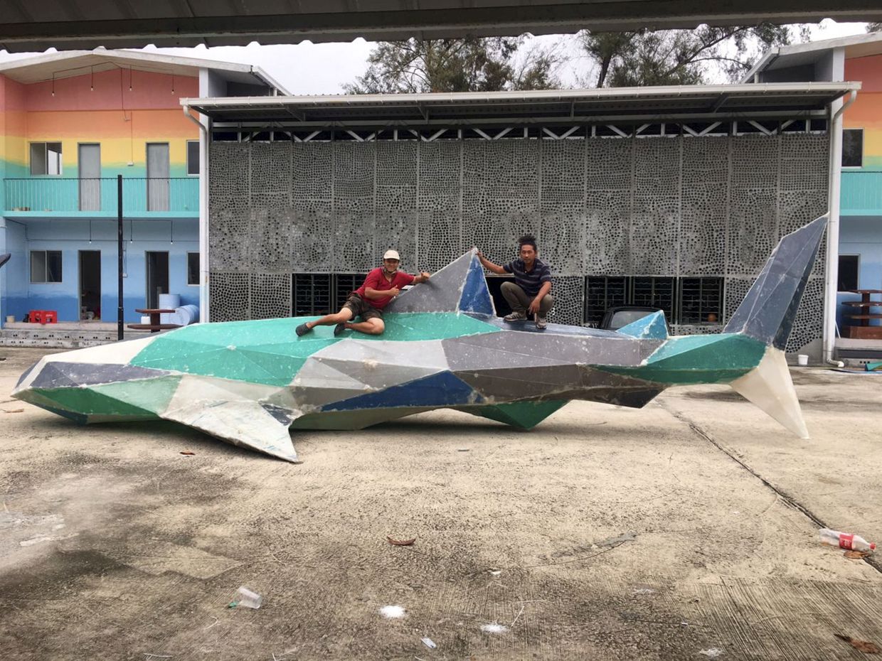 Japson Wong (left) giving the thumbs up while working on one of the 3D life-sized artworks. Wong is one of the winners of the Star Golden Hearts Award 2023.