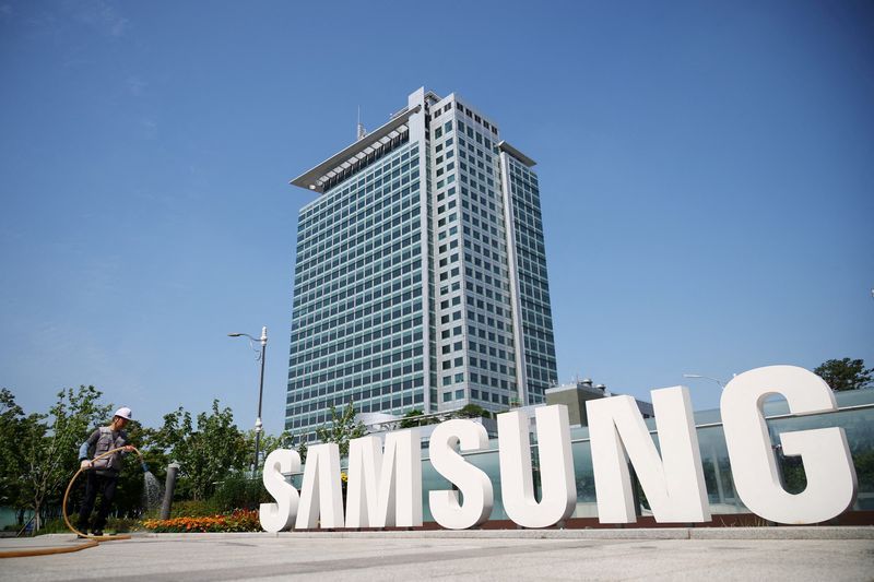 A worker waters a flower bed at Samsung Electronics headquarters in Suwon South Korea June 13 2023. REUTERSKim Hong-JiFile Photo