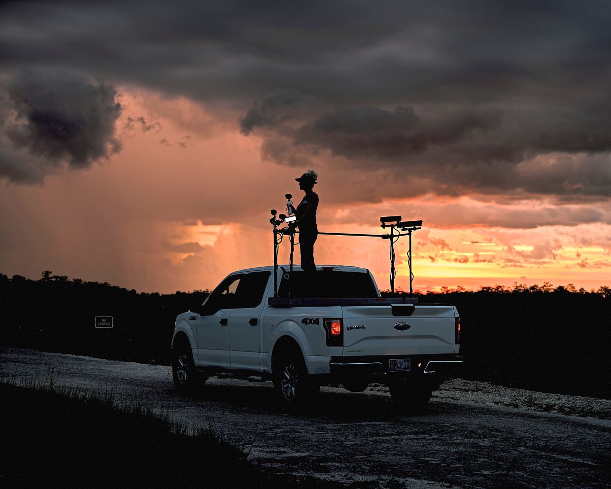 Siewe preps her truck to go python hunting with her fiance Roberts, outside of the Fakahatchee Strand Preserve in Florida. Siewe’s pickup truck is outfitted with spotlights, which help find invasive creatures lurking in the shadows. — ©2023 The New York Times Company