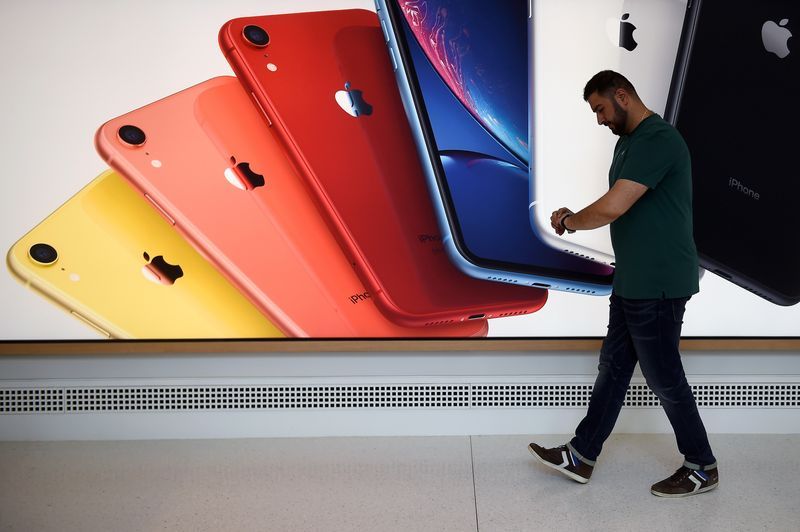 FILE PHOTO An Apple Store employee checks their Apple Watch during the grand opening and media preview of the new Apple Carnegie Library store in Washington U.S. May 9 2019. REUTERSClodagh KilcoyneFile Photo