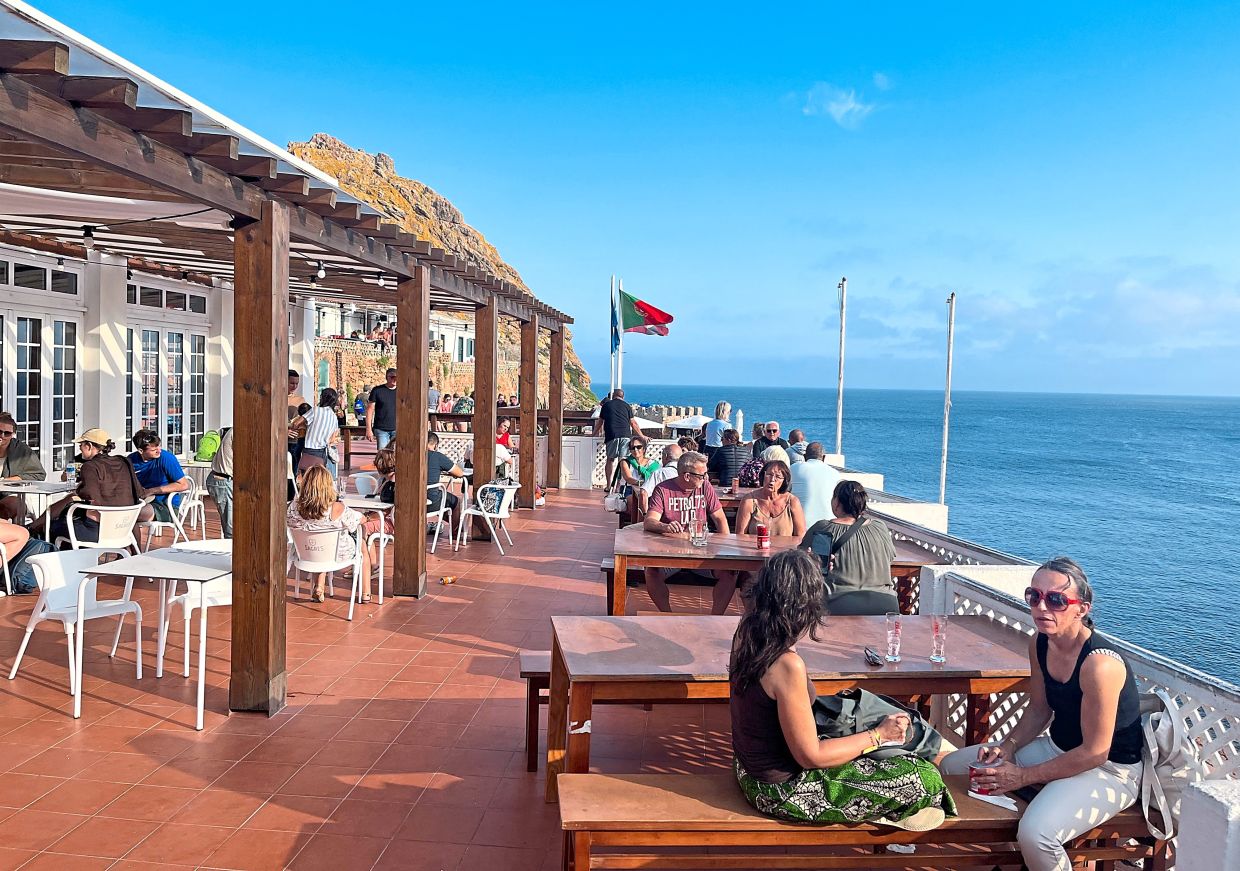 Visitors to Berlenga soaking in the sun, sights, sparkling sangria and Sagres beer at a restaurant.
