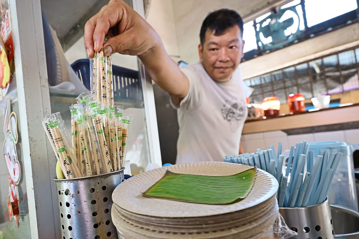 Fried noodle seller Chan Wai Kit has switched to disposable plates and utensils at his stall in Balik Pulau market.