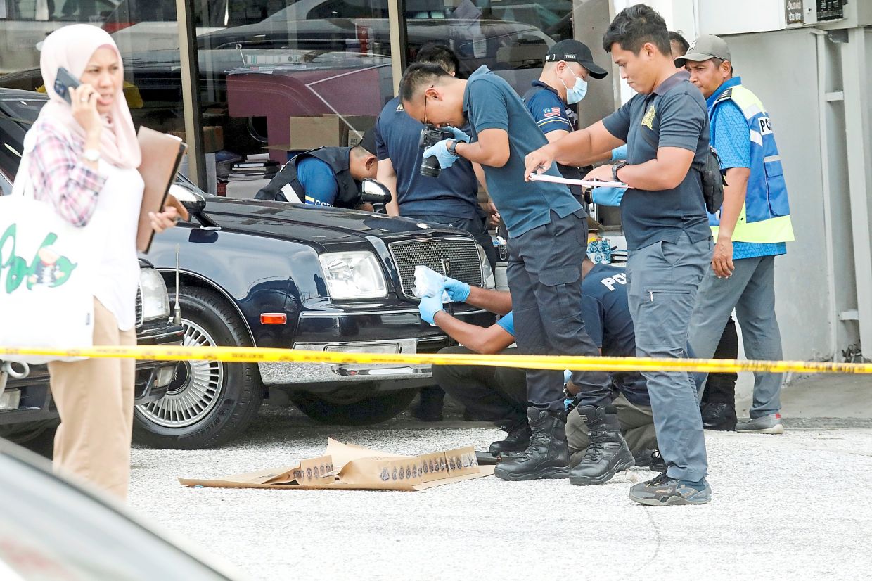 The police investigating a 'bomb-like' object under Siti Kasim's car last year. — Agencies