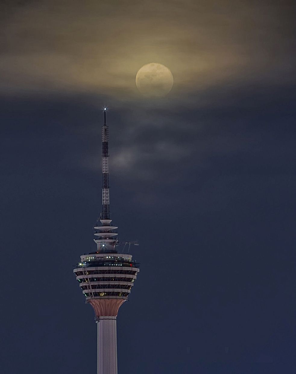 The moon over the Telekom tower in Kuala Lumpur. Such an opportunity comes only once or twice a year. - Pic by Eddie Chua