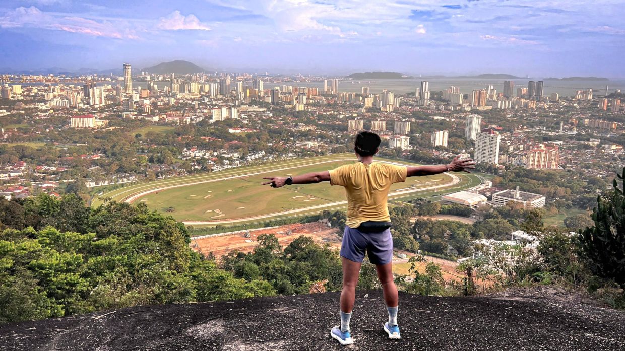 This gigantic boulder, unofficially named Astro Rock, gives hikers a glorious view of the horse racing circuit, the heart of George Town, Penang Bridge and mainland Penang across the channel. — Photo courtesy of KRYSTAL KHAW