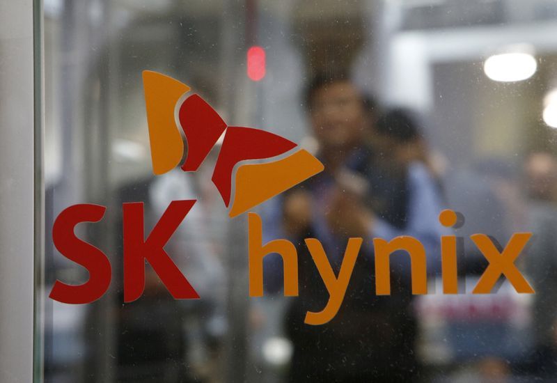 FILE PHOTO Employee walk past the logo of SK Hynix at its headquarters in Seongnam South Korea April 25 2016. REUTERSKim Hong-JiFile Photo