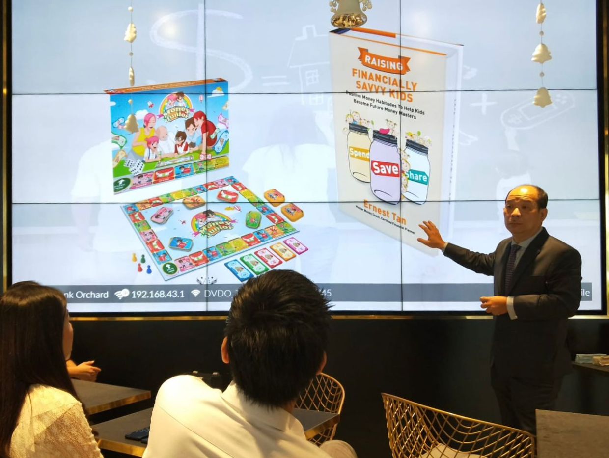 Tan at a workshop where he talks to parents about financial literacy among children. — Photos: ERNEST TAN