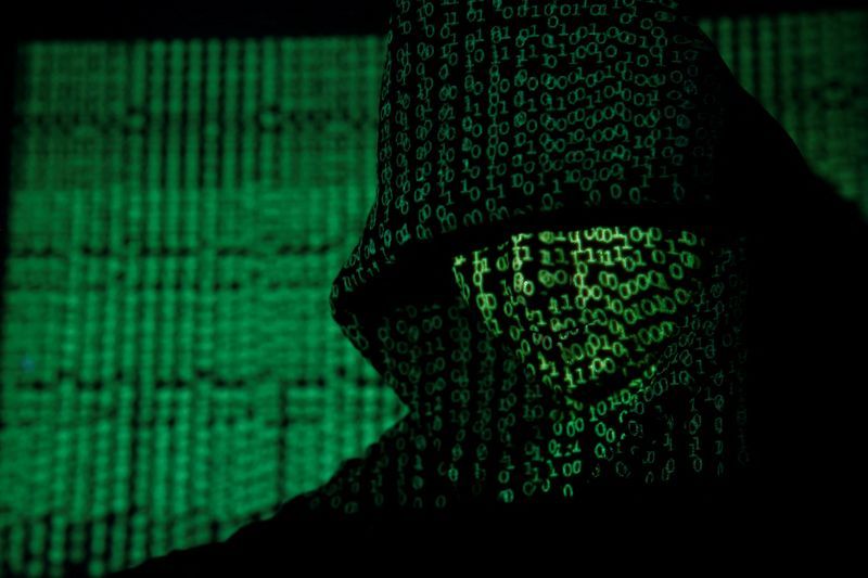 A projection of cyber code on a hooded man is pictured in this illustration picture taken on May 13 2017. REUTERSKacper PempelIllustrationFile Photo