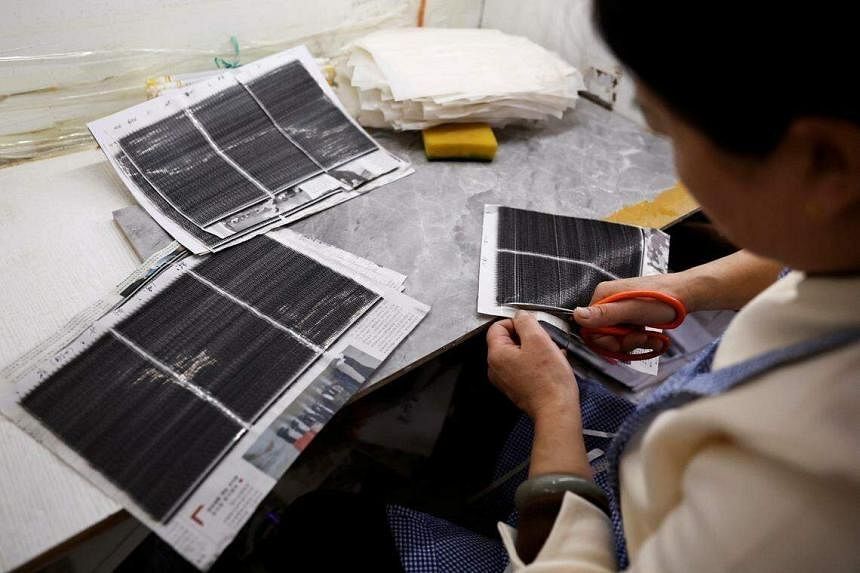 A worker works on a production line manufacturing false eyelashes at a workshop of Monsheery, in Pingdu, Shandong province, China on Nov 16, 2023. PHOTO: REUTERS