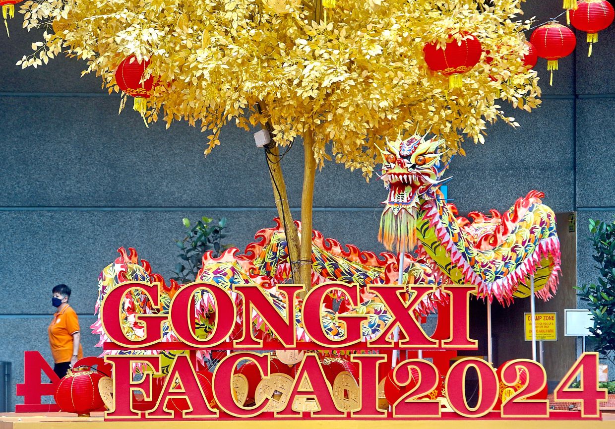 Members of Xuan Long Dragon and Lion Dance KL troupe gearing up for dragon dance performances for the Lunar New Year.