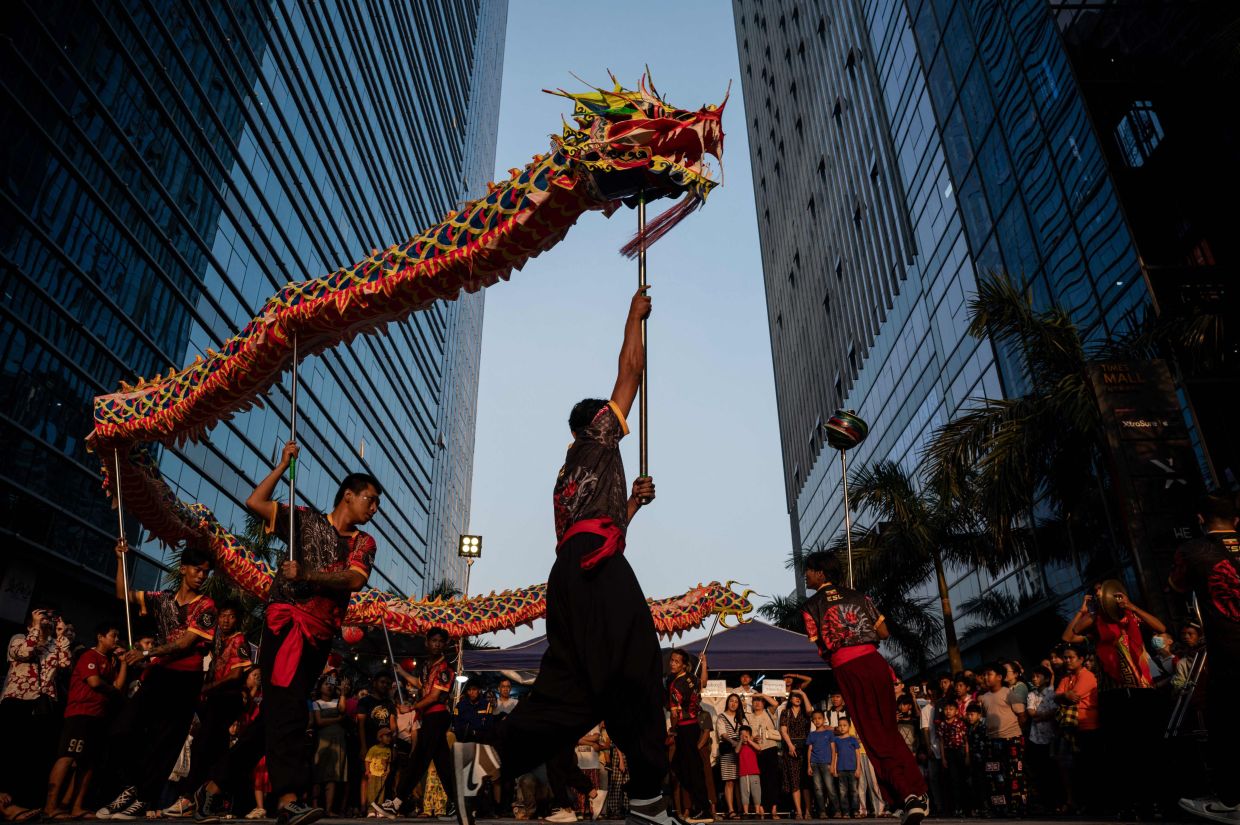 A dragon dance team performs on a street in Yangon on Saturday, February 10, 2024, on the first day of the Lunar New Year of the Dragon. - AFP