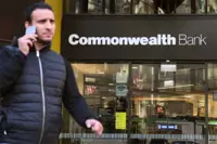 Australia's biggest bank warns of economic downside as profit dips