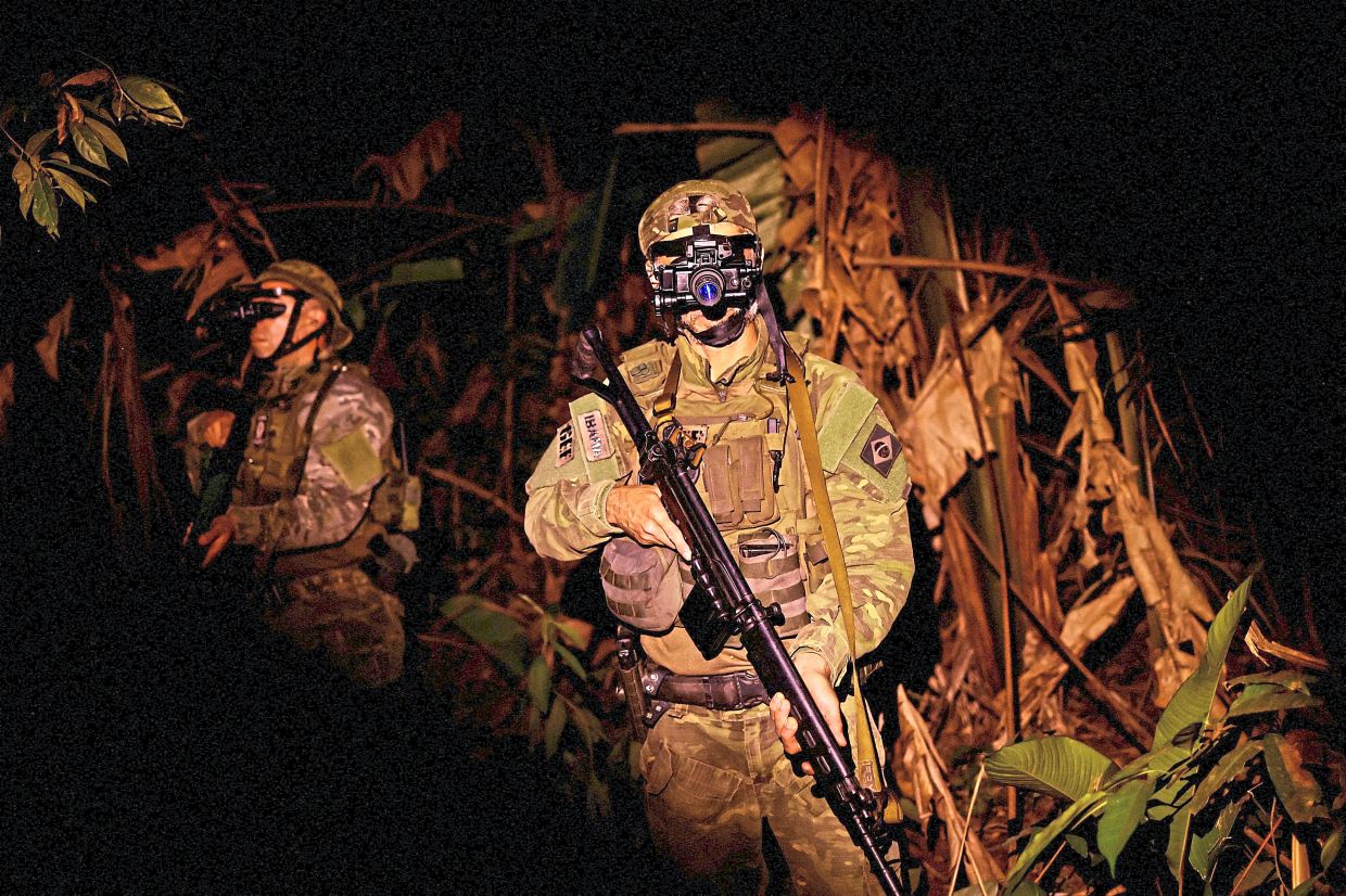 Members of the Special Inspection Group using night vision goggles on patrol. — Reuters