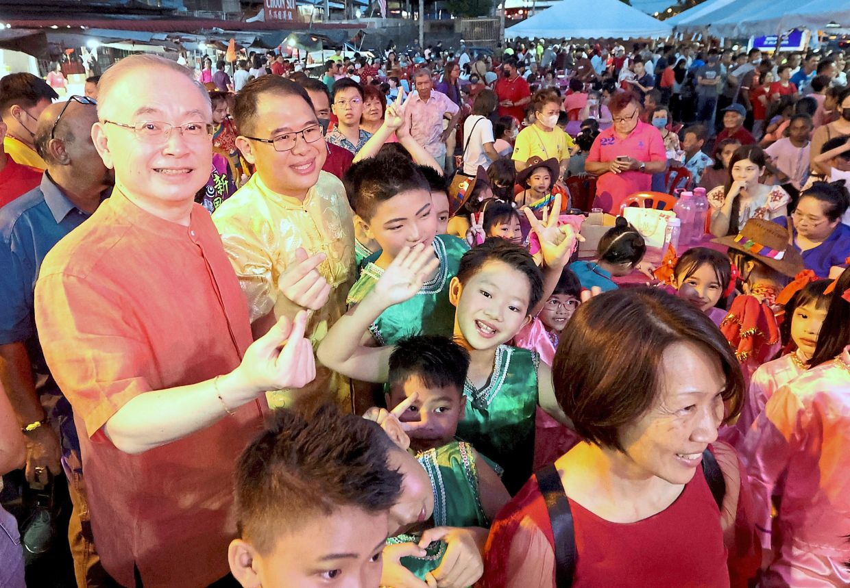 One for the album: Dr Wee and Ling taking photos with those attending the Chinese New Year celebration at the Yong Peng MCA building. — THOMAS YONG/The Star