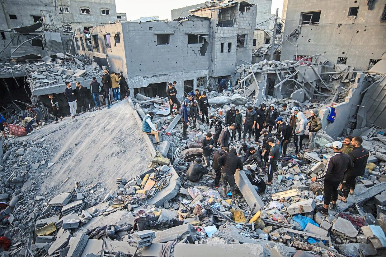 Palestinians searching through the rubble of a destroyed building for survivors following an Israeli airstrike in the Nuseirat refugee camp, central Gaza. — Bloomberg