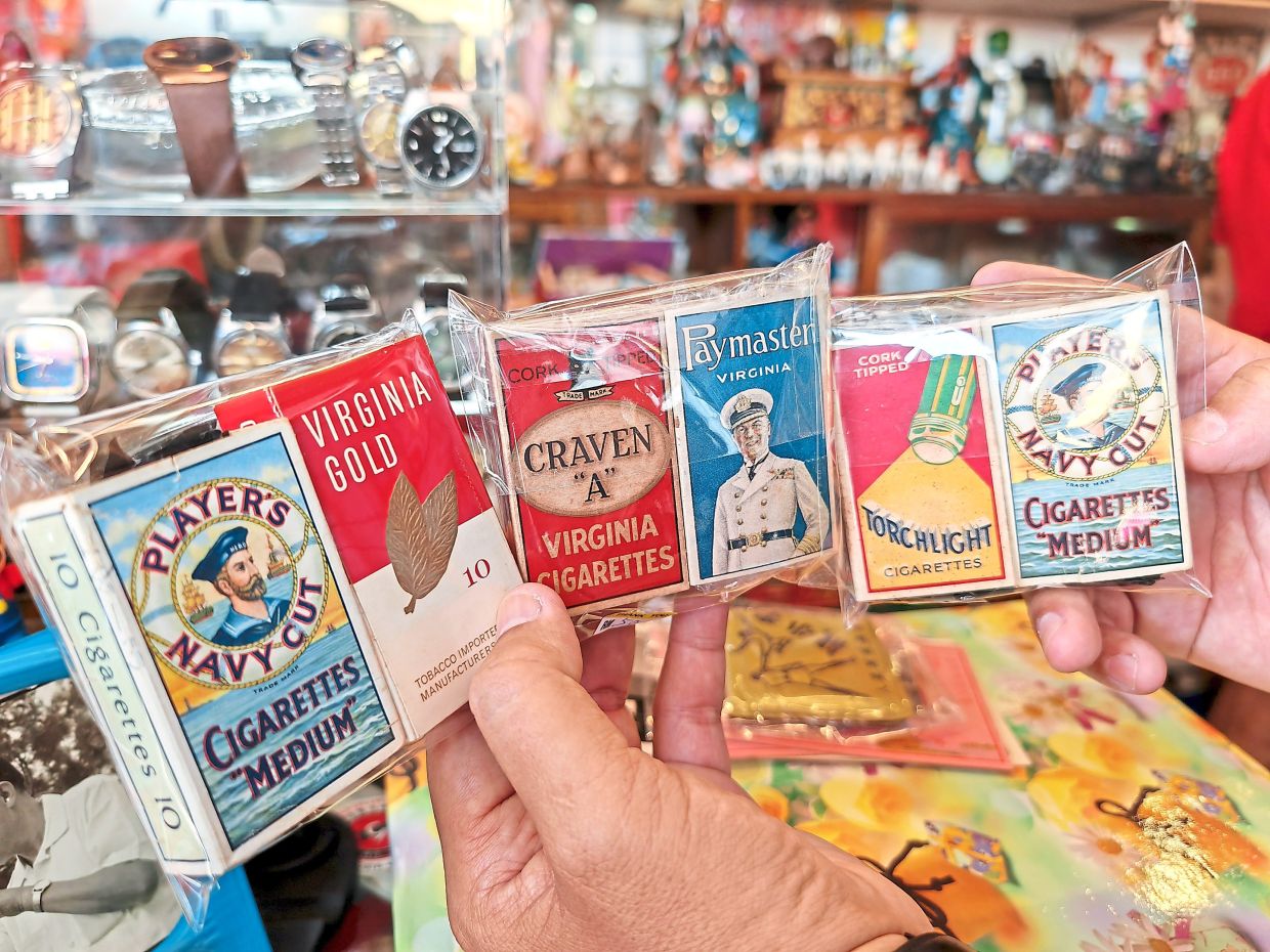 Old cigarette boxes are among the items at the stall.