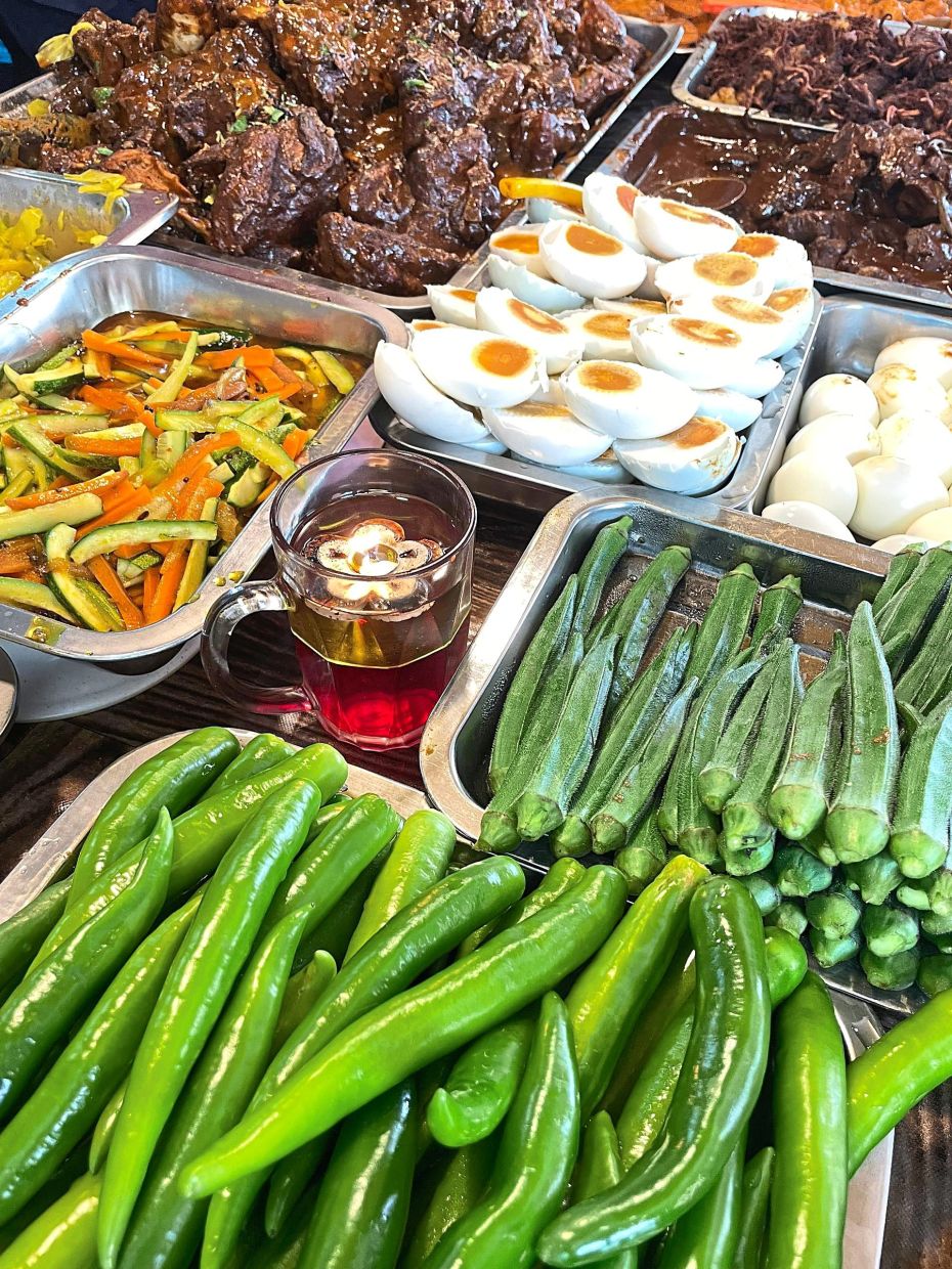 Salted egg and blanched lady’s fingers are popular at nasi kandar restaurants.