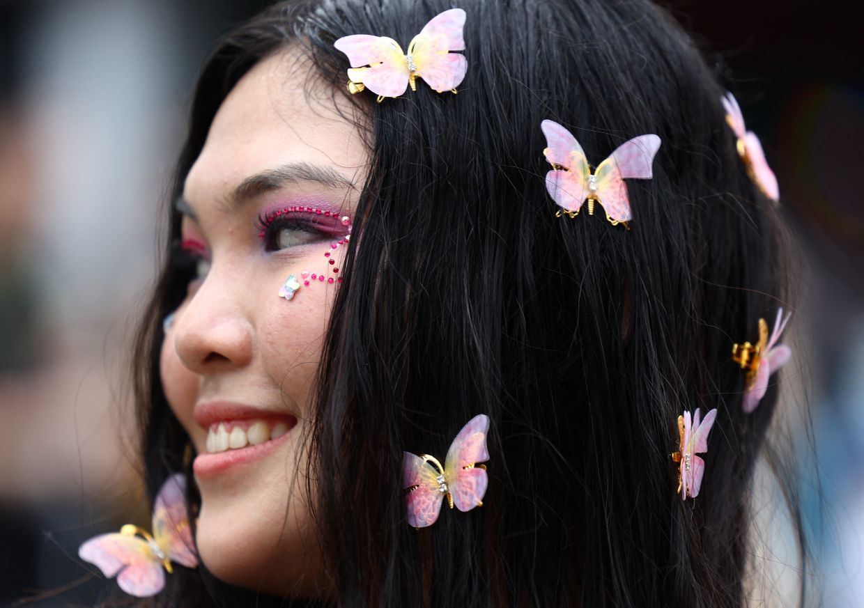 Natalia, 24, a Taylor Swift fan from Jakarta, Indonesia, shows the butterflies on her hair inspired by Swift's Lover era ahead of her concert in Singapore, on Friday, March 8, 2024. - Reuters