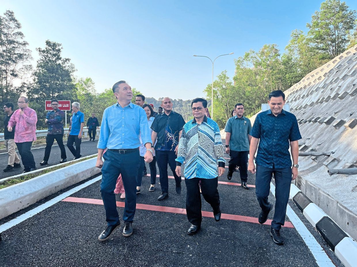 Ng (front, left) and Mohd Fauzi (centre) taking a closer look at the new road.