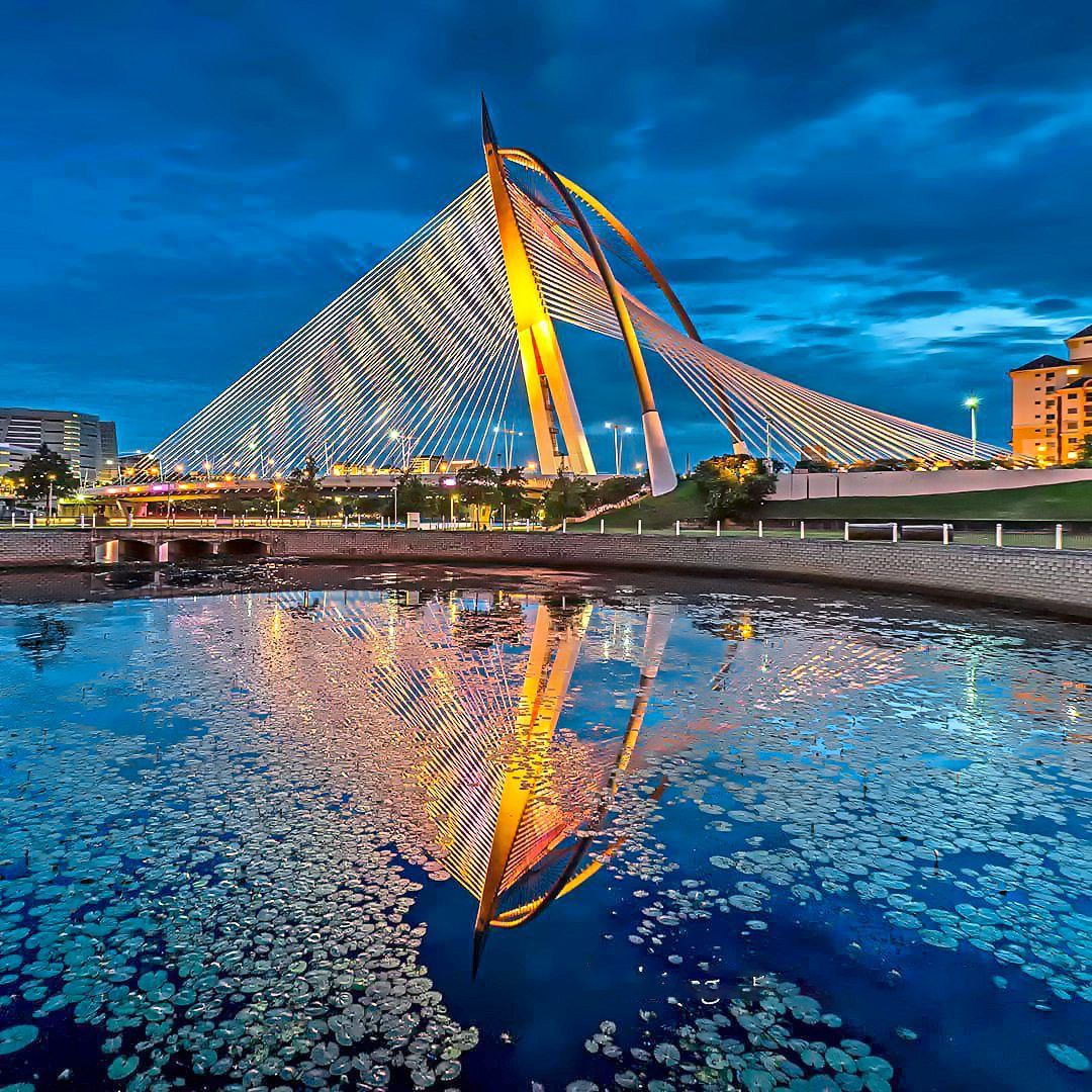 The gentle glow of golden hour light and illuminating lights on a Putrajaya bridge can produce stunning symmetrical compositions.