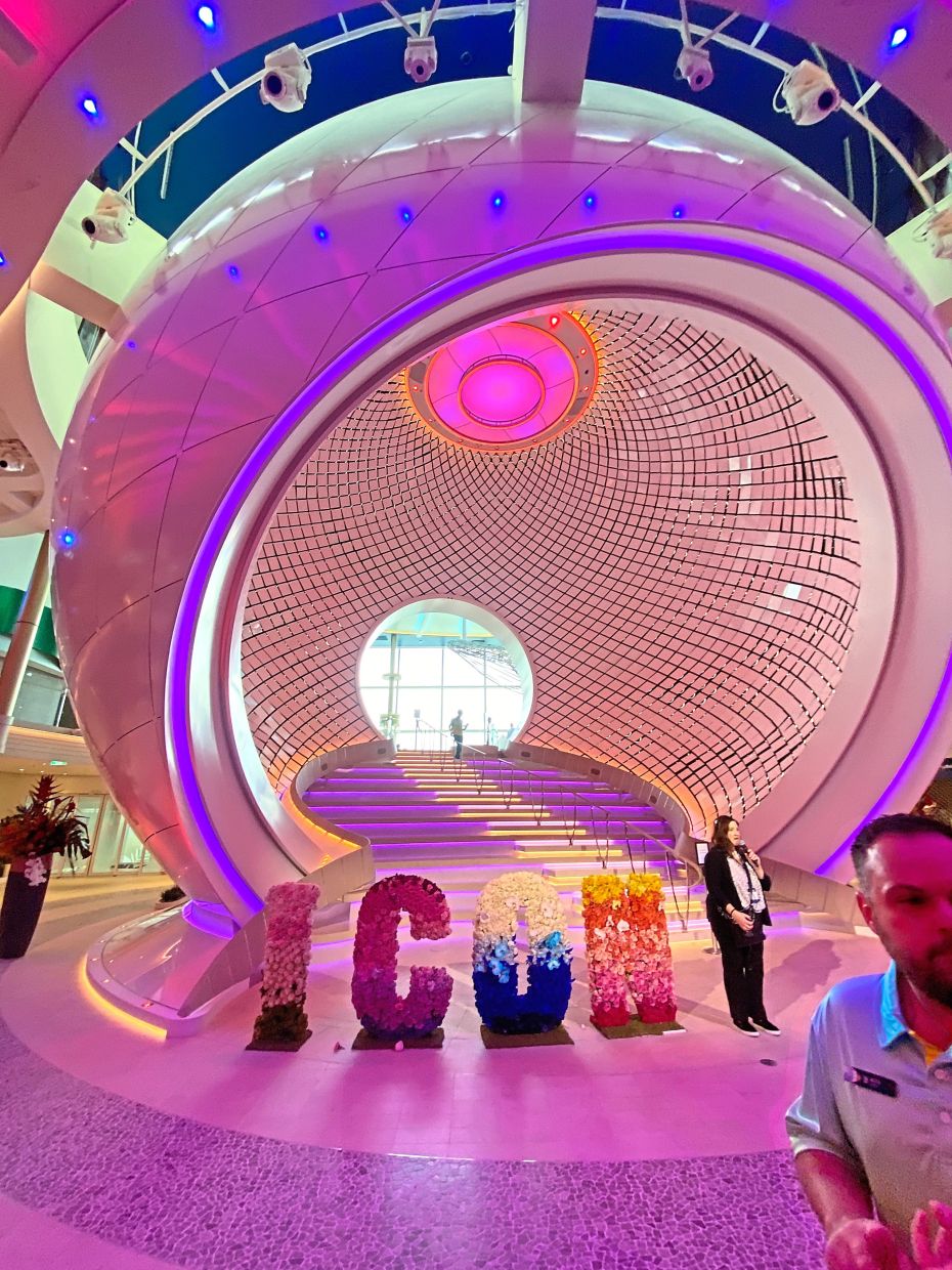 Tourists posing by The Pearl a giant kinetic art installation at The Royal Promenade