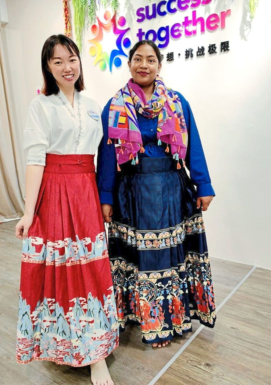 Cultural couture: Rakiba (right) and Wong posing for a picture while wearing mamianquns.
